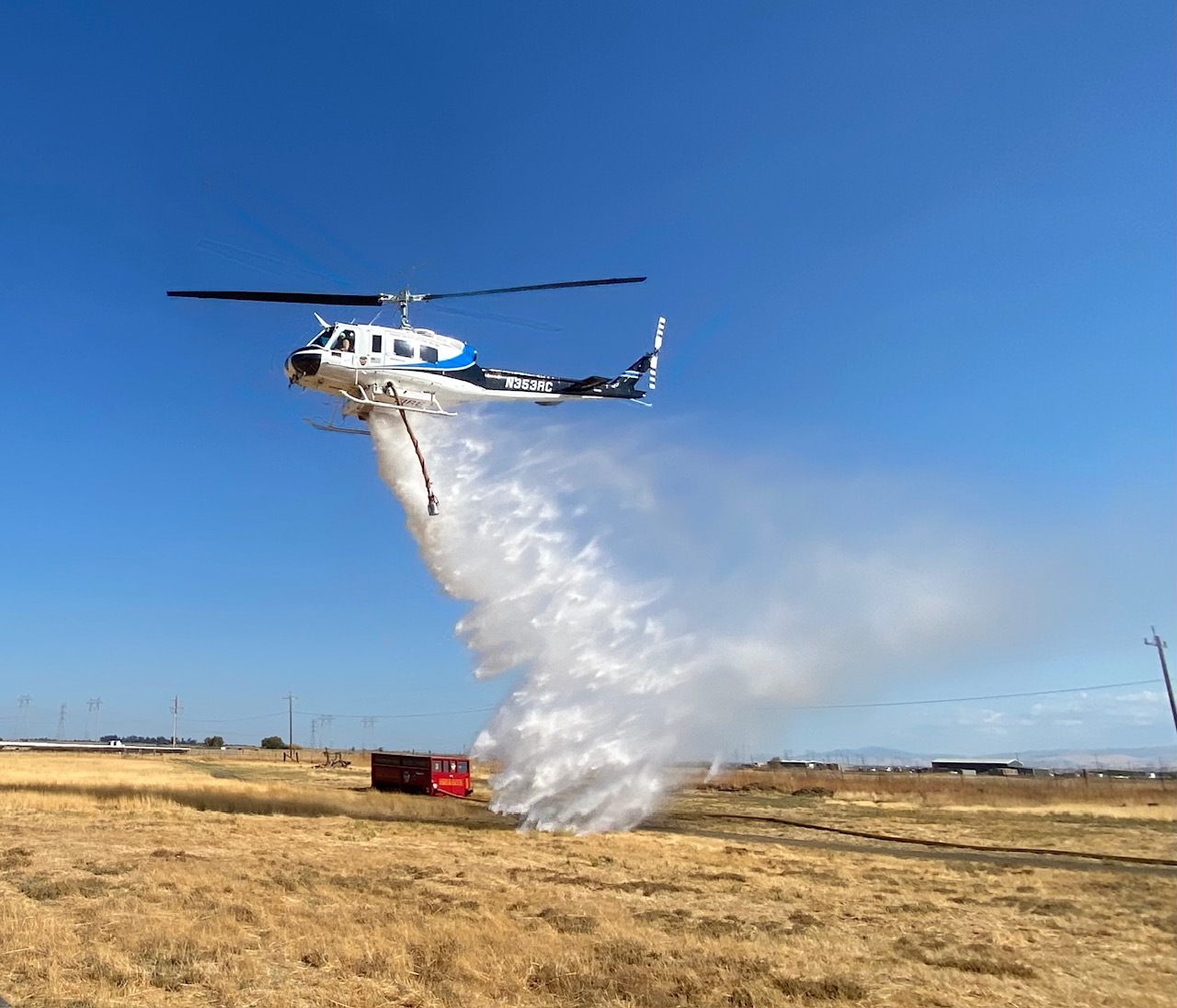 ConFire's Bell HU-1 helicopter, also known as Huey, demonstrates a water drop at the Byron Wildland Fire Center.