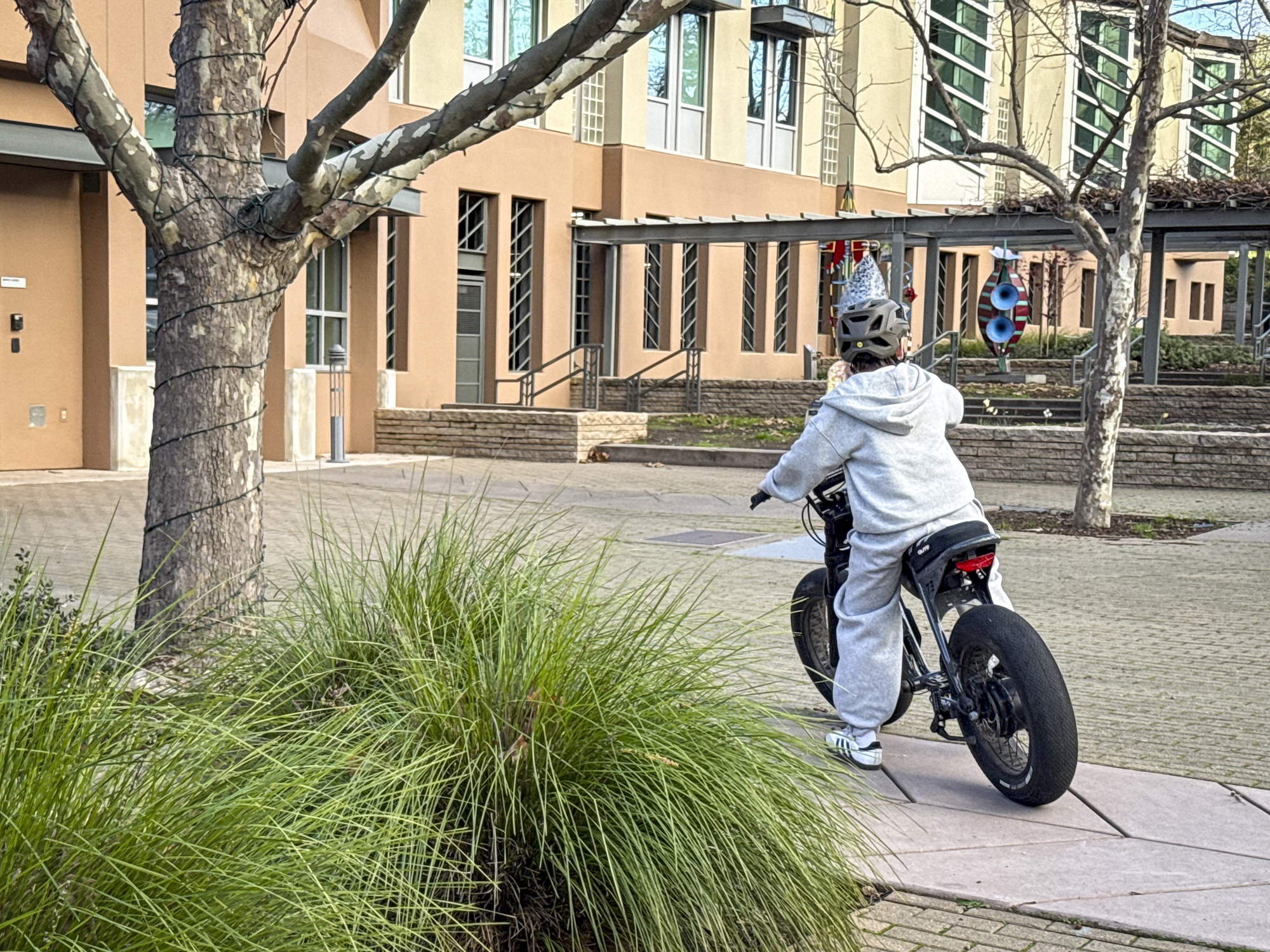 A young e-bike user drives around downtown Orinda on Jan. 7.