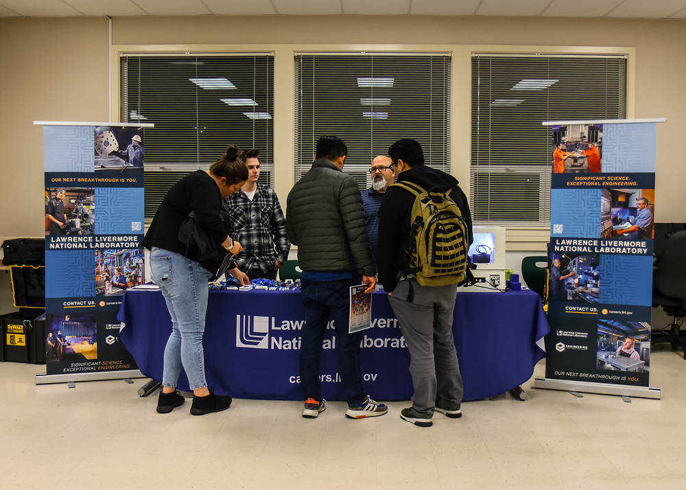 Participants gather around the Lawrence Livermore National Laboratory table during the recent career fair.