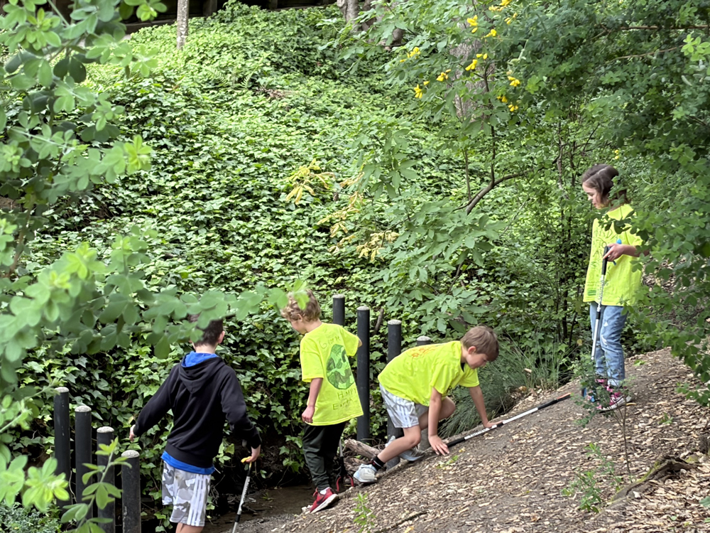 Local kids hunt for trashy treasures on April 25 on the hillside behind Orinda Community Park.