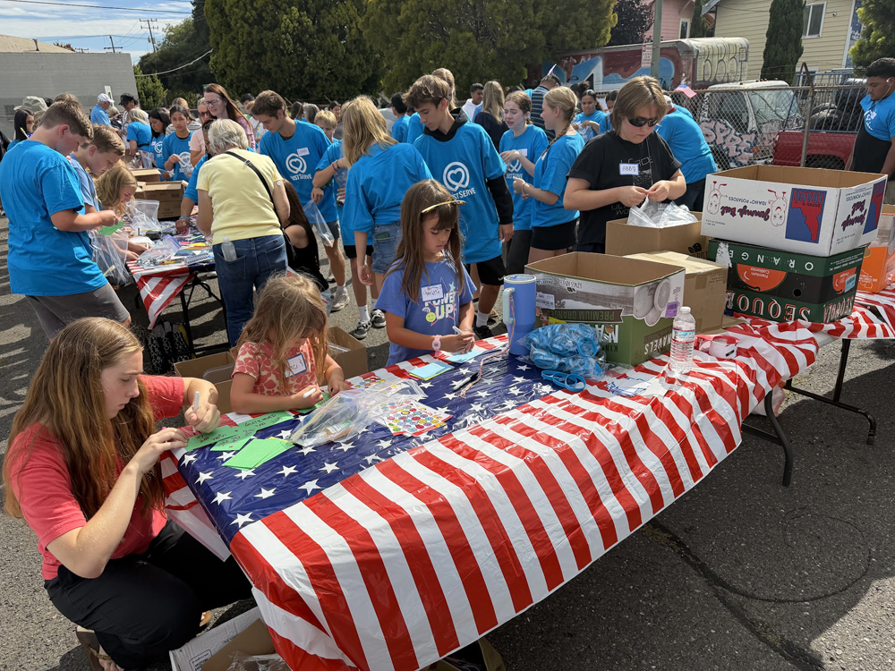 Volunteers assemble 1,000 hygiene kits for the homeless as part of the July 21 service project.