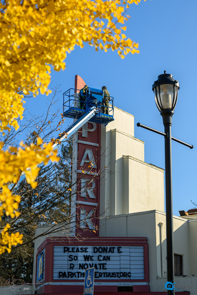 Jim Rizzo from NeonWorks in Berkeley removes the original Novial glass neon tubing from the Art Deco Park Theater tower on Dec. 5 to keep it safe and restore it.